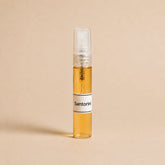 Frasco de 5 ml de la fragancia textil Santorini de SimLi con líquido visible sobre fondo beige