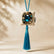 Colgante decorativo textil Zafiro de Ibiza de SimLi Atelier con cristal azul y borla turquesa